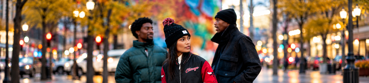 Shop Fanatics fanwear: three models in an autumn city scene.